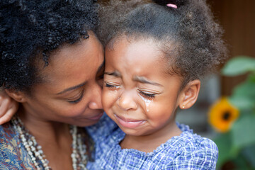 Emotional moment between mother and daughter as they share tears together Generative AI