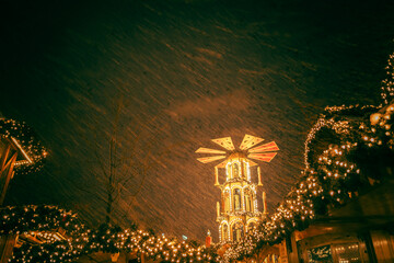 Magical Winter Night in Berlin with Falling Snow and Warm City Lights