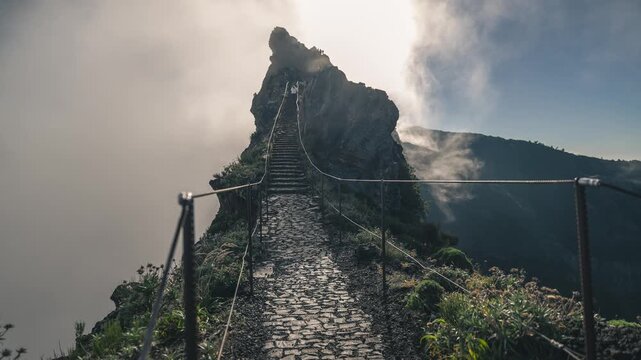 Vibrant daytime timelapse captured famous Stairway to Heaven (Escadas do C&eacute;u) near Pico do Arieiro, Madeira. Camera is positioned on the trail where stairs begin, capturing hikers moving up and down