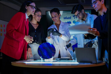 Specialist team of engineers and executives inspecting a large silicon wafer in a high-tech semiconductor laboratory. Discussion on microchip and RAM memory manufacturing process and quality control.