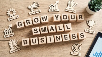 Fototapeta premium Wooden cubes spelling 'Grow Your Small Business' on table, symbolizing strategy, marketing, growth, planning, success, goals
