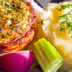 Baked meat with cheese and mashed potatoes with fresh vegetables as a side dish
