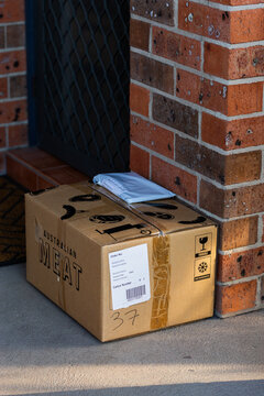 Online shopping delivery parcels sitting outside front door of house