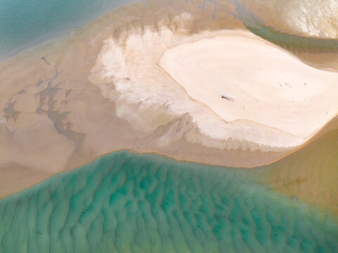 Aerial view of abstract pattern and water flow over sand in a coastal lake system