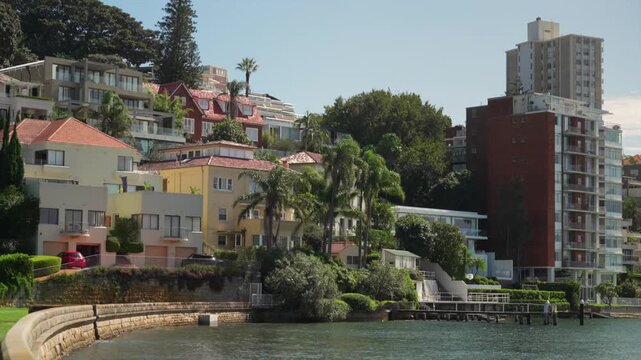 Waterfront apartment buildings and residential homes lining the harbour shoreline in Double Bay, Sydney