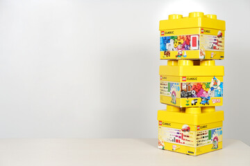 Obraz premium Minsk, Belarus - September 10, 2025: Lego constructor boxes stacked on a table with a white background, showcasing vibrant colors and playful designs, perfect for creative building concepts