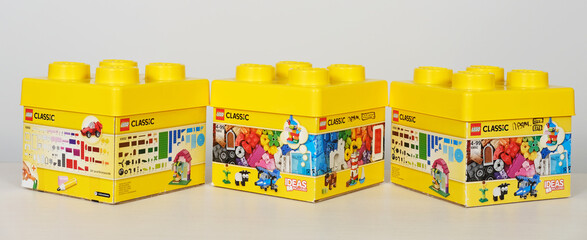 Obraz premium Minsk, Belarus - September 10, 2025: Lego Classic building blocks in vibrant yellow boxes displayed on a white background, showcasing creativity and playfulness with copy space