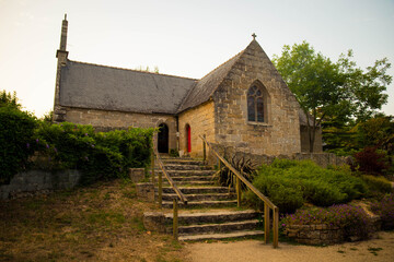 Chapelle Saint-Nicolas, a small granite church in Port-Manech, Brittany, France. Exterior building with no people at sunset.
