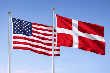 United States and Denmark Flags Waving on Flagpoles Against a Clear Blue Sky