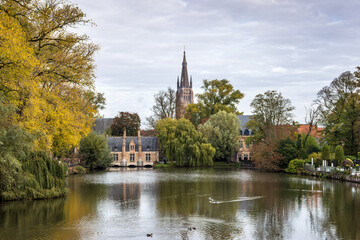 Naklejka premium View over the Minnewater lake and the Sashuis (Lock keeper's house) in Bruges, Belgium. 