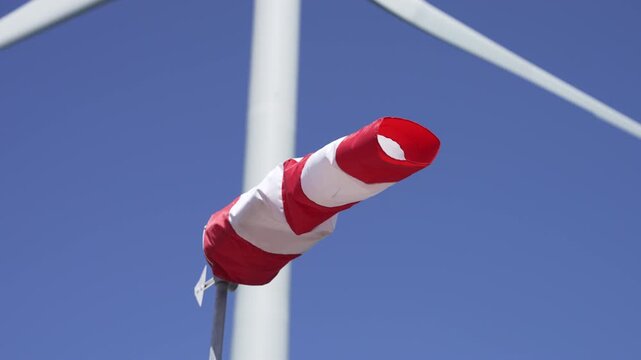 Windsock with a wind wheel in the background.