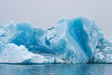 Giant melting iceberg, close up. J&ouml;kuls&aacute;rl&oacute;n or "glacial river lagoon" is a largest and most active glacial lake in southern part of Vatnaj&ouml;kull National Park with large blue icebergs or ice melting. 