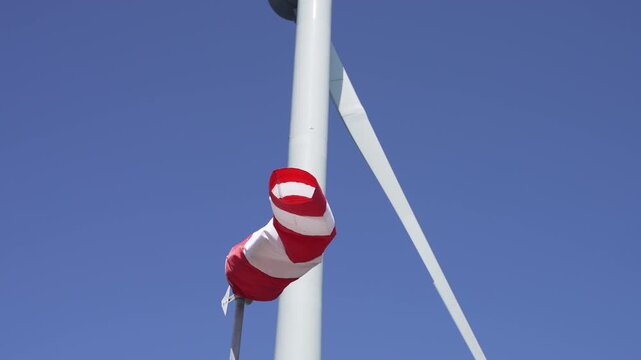 Wind cone with a wind wheel in the background