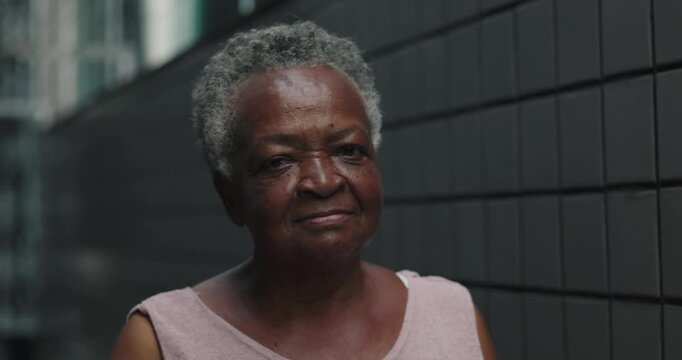 Elderly African American woman standing in corridor with calm, steady expression, quiet strength, lived wisdom, reflective presence, everyday dignity