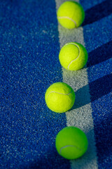 Close up of aligned tennis balls on blue ground. The Concept of Organization.