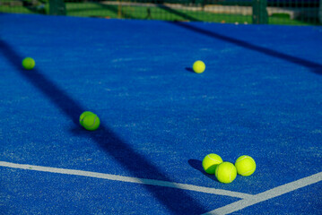 Scattered tennis balls on blue court surface. The Concept of Training.