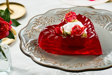 Red heart-shaped Jelly Dessert with Roses on Elegant Table Setting