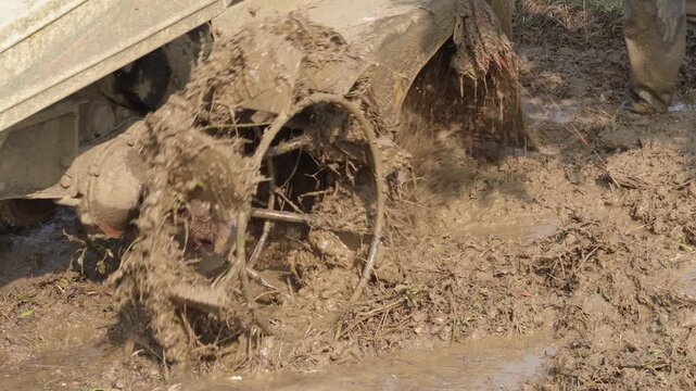 The tractor wheel is covered by myd while plowing the field