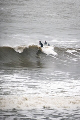Surfers in winter in the North Sea
