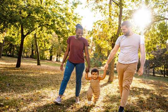 Joyful family stroll in a vibrant park during golden hour