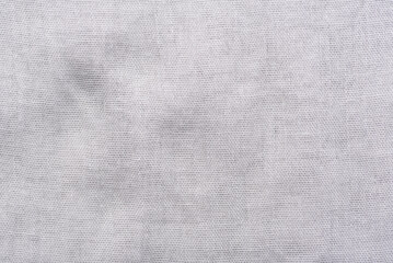 Detailed macro shot of a dark gray cotton material surface.