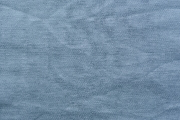 A close-up view of soft, organic cotton textile with a subtle, visible weave pattern.