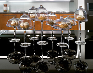 Still life of crystal trays, shaped like glasses, with sweets inside