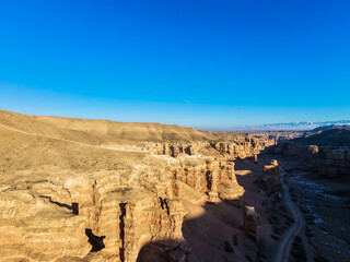 Evening shadows of the Charyn Canyon encroach on the cliffs.