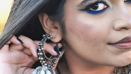 Bangladeshi girl wearing traditional jhumka earring and blue eyeliner makeup