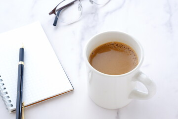 Memo Pad and pen with a cup of Coffee
