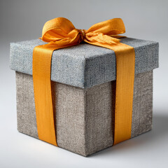 Elegant gift box with a vibrant orange ribbon and bow, ready for celebration