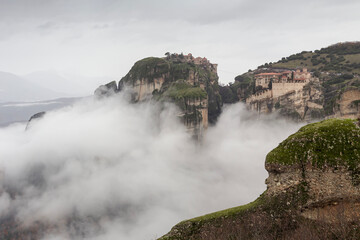 Orthodox monasteries of Meteora (Greece) on the rocks shrouded in fog