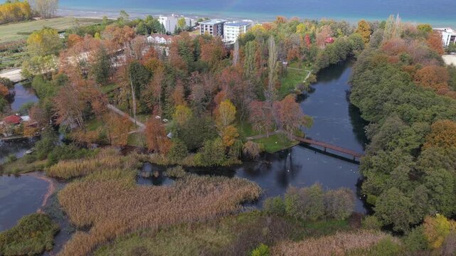 Aerial video of Drilon National Park with a wooden bridge and Lake Ohrid under autumn light.
