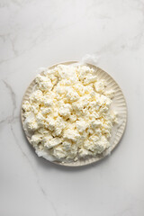 Top view of curd  cottage cheese dairy product on light surface