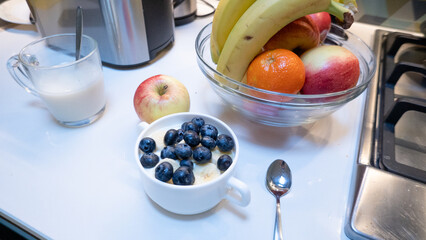 Healthy breakfast with yogurt, blueberries, and fresh fruit