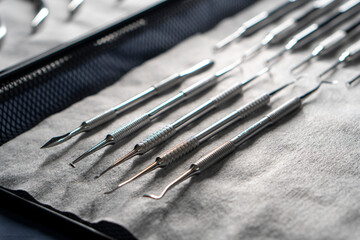 Sterile stainless steel nail care instruments on a medical tray. Close-up