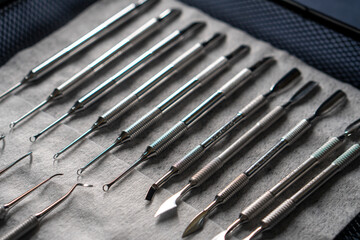 Sterile stainless steel nail care instruments on a medical tray. Close-up