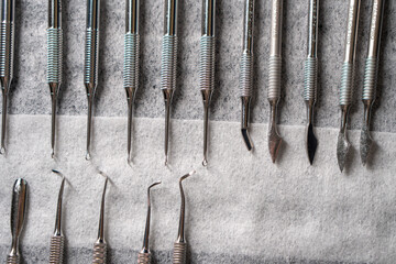 Sterile stainless steel nail care instruments on a medical tray. Close-up