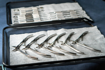 Sterile stainless steel nail care instruments on a medical tray. Close-up