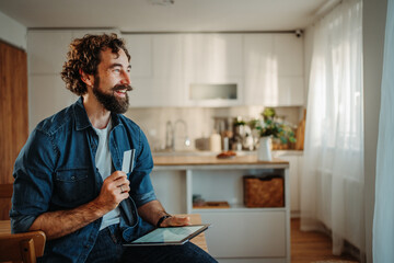 Happy man shopping online with credit card
