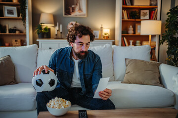 Man gambling on soccer suffering loss and disappointment