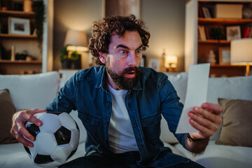 Man experiencing shock while winning football bet