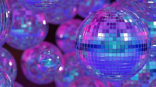 A collection of illuminated, varying-sized disco balls hanging in the air, displaying blue and pink patches against a dim background