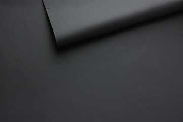 Dark gray paper texture with a slightly folded corner minimalistic composition