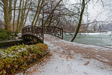 Snow on the trees and the lake of Parc de la Tete d'Or in Lyon, France