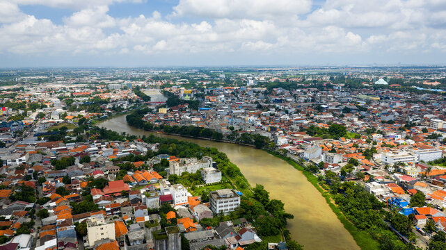 Urban river in Tangerang City, Banten, Indonesia with reflections on the water and a relaxed city atmosphere.