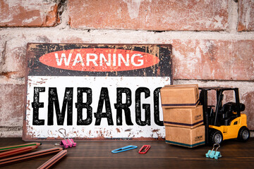 Warning Embargo Sign With Cargo Boxes And Forklift Supply Chain Concept