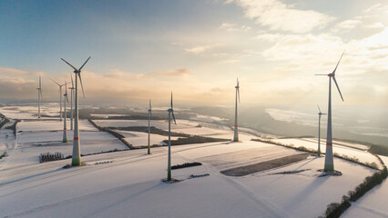 Windless wind turbine in snow, dark doldrums or wind lull in winter, renewable sustainable energy,...