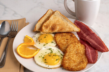 fried eggs  with turkey bacon  and hash browns