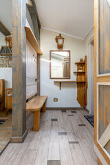 Rustic wooden entrance hall with bench mirror shelves beams lantern